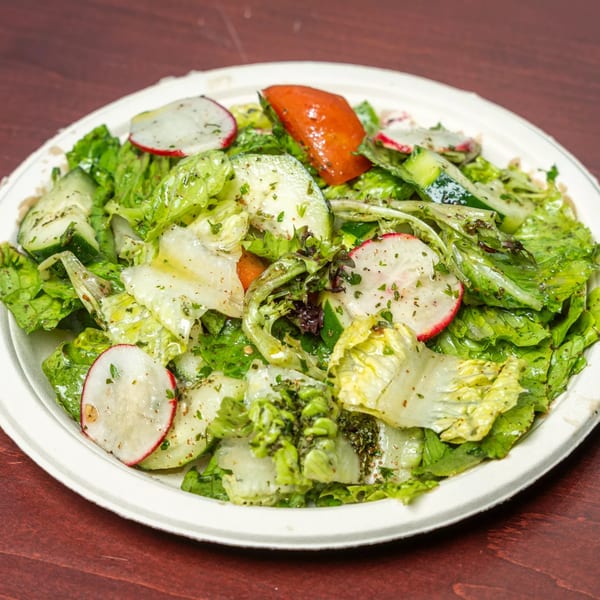Hovan Gourmet Mediterranean salad with lettuce, cucumbers, radishes, and tomatoes in a white bowl.