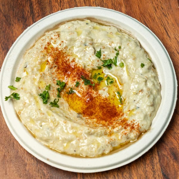Hovan Gourmet's creamy baba ghanoush, drizzled with olive oil, paprika, and fresh parsley.